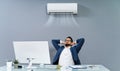 Businessman Enjoying The Cooling Of Air Conditioner