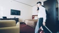 Businessman entering hotel room after check-in. Travel, business and people concept Royalty Free Stock Photo