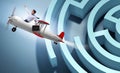 Businessman escaping from maze on airplane