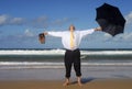 Businessman escaping to a beach vacation, arms outstretched, retirement happiness concept Royalty Free Stock Photo