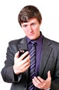 Businessman evil looks at the mobile phone Royalty Free Stock Photo