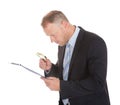 Businessman Examining Document On Clipboard Royalty Free Stock Photo