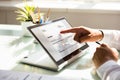 Businessman examining invoice on laptop Royalty Free Stock Photo