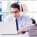 Businessman with excessive work paperwork working in office Royalty Free Stock Photo