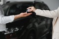 businessman exchange handing over the car keys for to a young women.