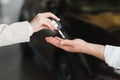 businessman exchange handing over the car keys for to a young women.