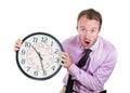 Businessman, executive, leader holding a clock, very determined, pressured by lack of time, running out of time, late for the meet Royalty Free Stock Photo