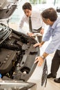 Businessman explaining the car details Royalty Free Stock Photo