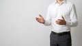 Businessman explaining idea with open hand gestures against clean studio background Royalty Free Stock Photo
