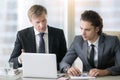 Businessman explaining presentation on laptop screen Royalty Free Stock Photo