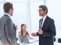 businessman explaining something to his colleague standing in the office. Royalty Free Stock Photo