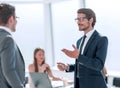 Businessman explaining something to his colleague standing in the office. Royalty Free Stock Photo