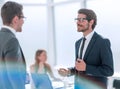 Businessman explaining something to his colleague standing in the office. Royalty Free Stock Photo