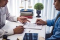 Businessman explaining terms and conditions with contract insurance agreement before he sign the document