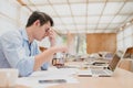 Businessman eyes pain. Tired, overworking and taking off glasses massaging eyes after long time working with laptop in office Royalty Free Stock Photo