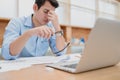 Businessman eyes pain. Tired, overworking and taking off glasses massaging eyes after long time working with laptop in office Royalty Free Stock Photo