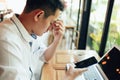 Businessman eyes pain. Tired, overworking and taking off glasses massaging eyes after long time working with laptop in office Royalty Free Stock Photo