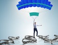 Businessman falling into trap on parachute Royalty Free Stock Photo