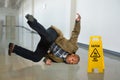 Businessman Falling on Wet Floor Royalty Free Stock Photo