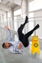 Businessman Falling on Wet Floor Royalty Free Stock Photo