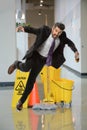 Businessman Falling on Wet Floor Royalty Free Stock Photo