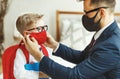 Businessman father accompanies his son to school putting on a mask to protect and prevent coronavirus