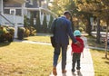 Businessman Father Walking Son On Scooter To School