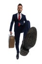 Businessman feeling insulted and kicking with his foot