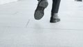 Businessman feet walking on urban street. Employee in black shoes going for work Royalty Free Stock Photo