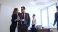 Businessman with female colleague flirts in office.