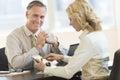 Businessman With Female Colleague Using Digital Tablet In Office Royalty Free Stock Photo