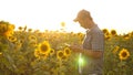 Businessman in field analyzes their income. agronomist studies crop of a sunflower. A farmer man works with a tablet in