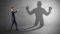 Businessman fighting with his unarmed shadow