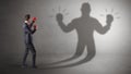 Businessman fighting with his unarmed shadow