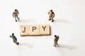 Businessman figures at JPY words