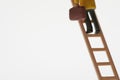 Businessman Figurine Climbing Ladder