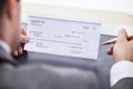 Businessman filling cheque Royalty Free Stock Photo