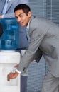 Businessman filling cup from water cooler Royalty Free Stock Photo