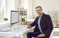 Businessman or financial accountant sitting at his office desk with a desktop computer Royalty Free Stock Photo