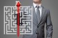 Businessman finding the solution of a maze