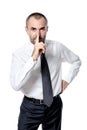 Businessman with finger near nose in silence gesture
