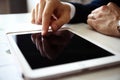 Businessman finger pointing to the screen of a tablet