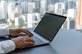 Businessman fingers typing on laptop, online business and skyscrapers, mockup Royalty Free Stock Photo