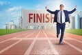 The businessman on the finishing line in competition concept