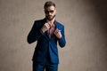 Businessman fixing his collar and looking at camera confident Royalty Free Stock Photo