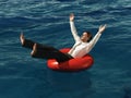 Businessman floating on lifebuoy