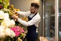 businessman florist in fridge with fresh bouquets