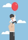 Businessman flying away with balloon but being hindered by large Royalty Free Stock Photo