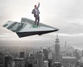 Businessman flying on paper plane in business concept Royalty Free Stock Photo