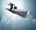 Businessman flying on paper plane in business concept Royalty Free Stock Photo